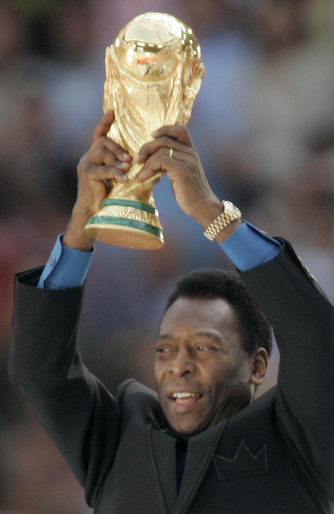 Brazil's soccer legend Pele raises the Word Cup trophy. (AP Photo/Thomas Kienzle)