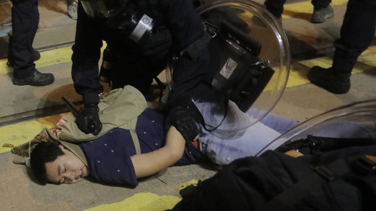 Police detain protesters after charging at them near the China Liaison Office after a protest against what activists say is police violence in Hong Kong.