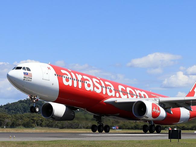 The inaugural Air Asia flight between the Gold Coast and Auckland City in New Zealand, Captain Jay Schledge and Mikey Long stand proudly in front of the Air Asia Airbus.