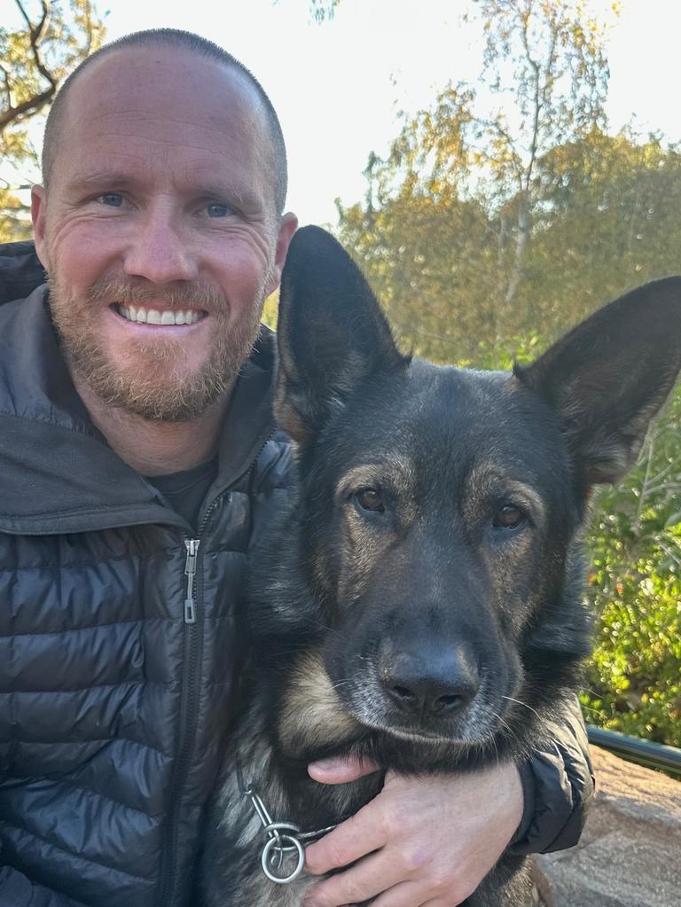 Handler Ben Fisher with his recently retired PD Rusty. Picture: Supplied.