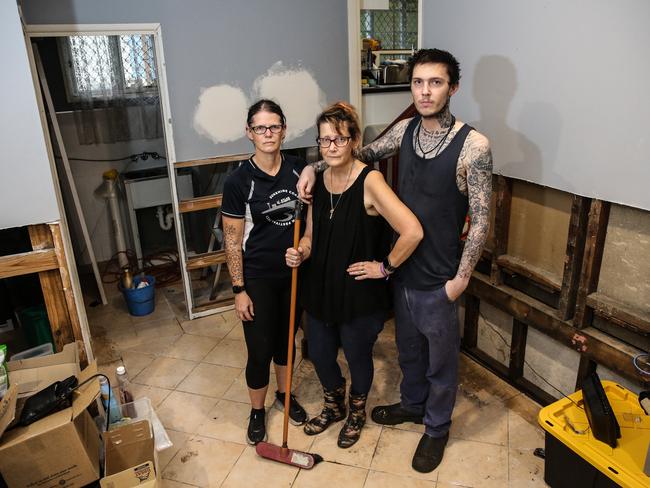 Deb Grgic (middle) alongside sister Karen Shield and son Addison Grgic as they are still cleaning up their Gladstone Street home in Oxley after the February floods. Picture: Zak Simmonds