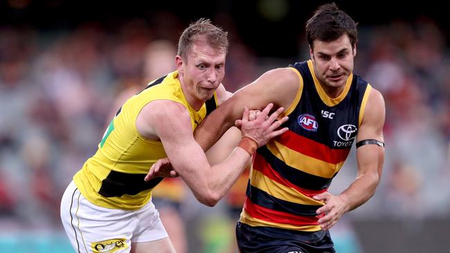 Dylan Grimes outmuscles Adelaide’s Darcy Fogarty in Round 18.