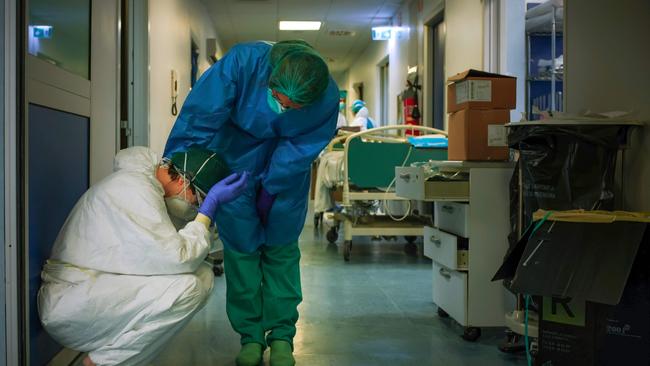 Nurses comfort each other at the Cremona hospital, southeast of Milan, Lombardy.