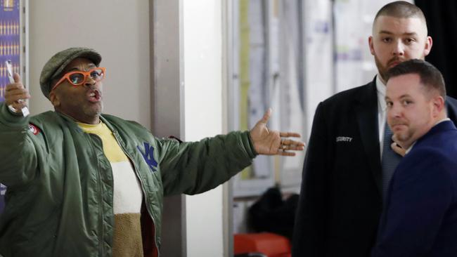 Director Spike Lee, left, gestures in a hallway on the event level at Madison Square Garden while arguing with security officers. (AP Photo/Kathy Willens)