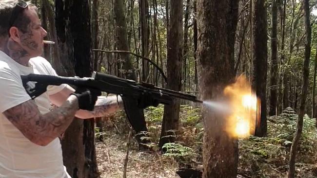 Matthew Bruce fires the gun while smoking