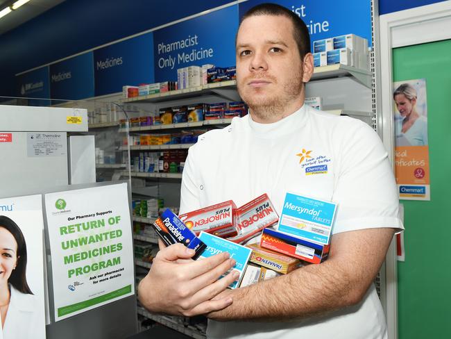 Pharmacist Sam Keitaanpaa with pain products that will become prescription only. Picture: Katrina Bridgeford