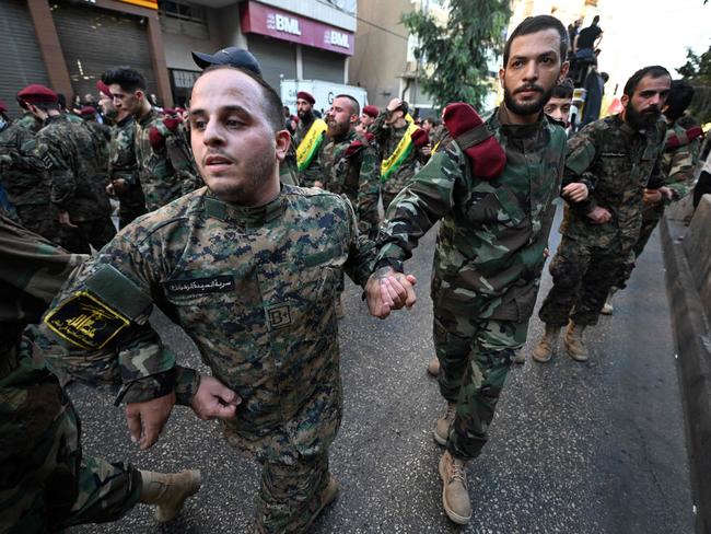 Hezbollah fighters form a human barrier during the funeral procession of slain top Hezbollah commander Fuad Shukr in Beirut's southern suburbs. Picture: AFP