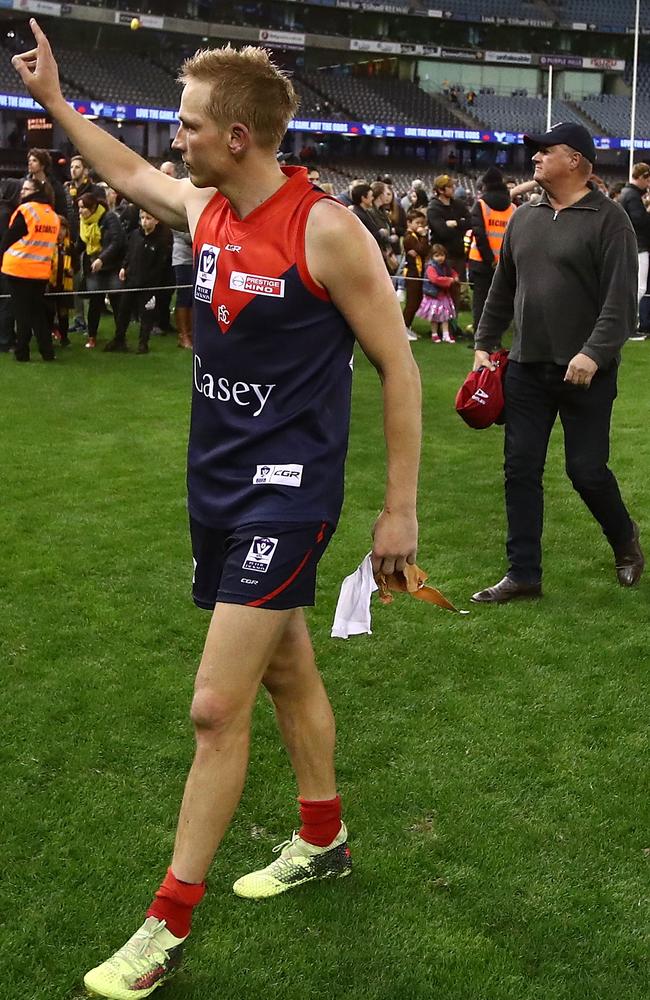 The retiring Bernie Vince waves to the crowd as he walks off Etihad Stadium.