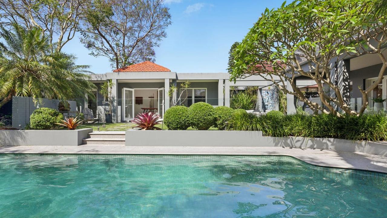 The home boasts a glass-framed mosaic pool.