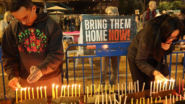 People light candles on a large menorah, to mark the end of Hannukah in Tel Aviv amid the ongoing war with Hamas. Picture; AFP.