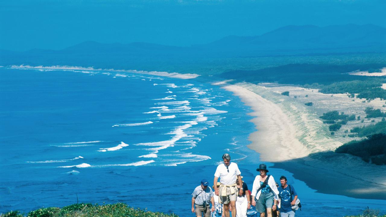 Tourists hike up Bustard Hill during a tour around the township of 1770 on the Discovery Coast, Queensland. Pic Tourism Queensland.