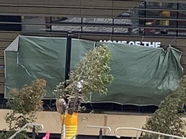 The "Home of the Sydney Roosters" sign at Allianz Stadium has been covered up by a $152 Bunnings tarpaulin.