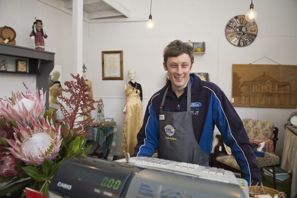 YellowBridge Queensland client Mikey Jones learns to use the cash register in the social enterprise op shop Collectables, Tuesday, June 7, 2016. Picture: Kevin Farmer