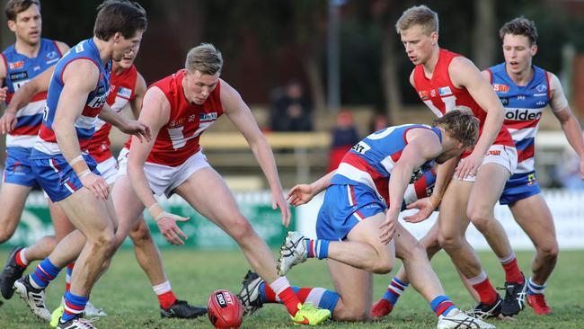 Players fight for the ball during the North Adelaide-Central District clash. Picture: AAP / Russell Millard