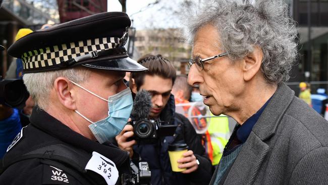 Piers Corbyn, right, brother of former Labour leader Jeremy Corbyn, confronts police outside the Bill and Melinda Gates Foundation in London. Picture: AFP.