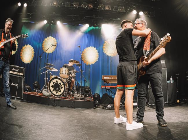 Peter Oxley gets a pre-birthday hug from son Nico at Sunnyboys' last Brisbane show. Picture: Curdin Wullschleger/Sunnyboys Fan Club/The Tivoli