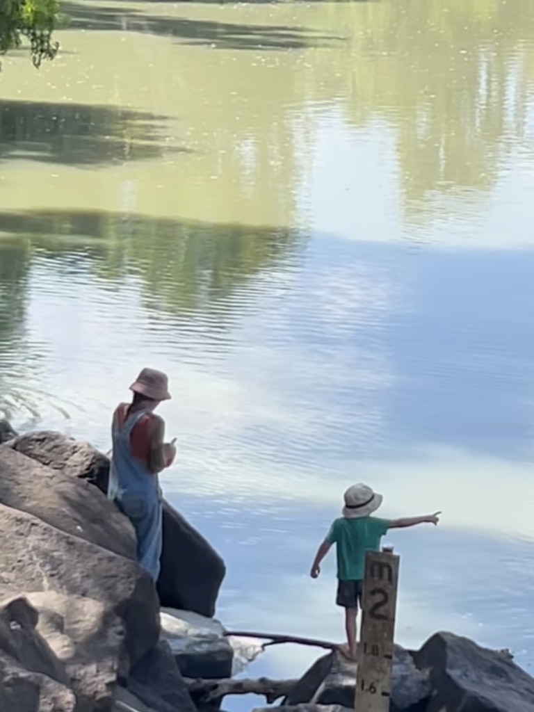 The child was filmed climbing over rocks at the water's edge.