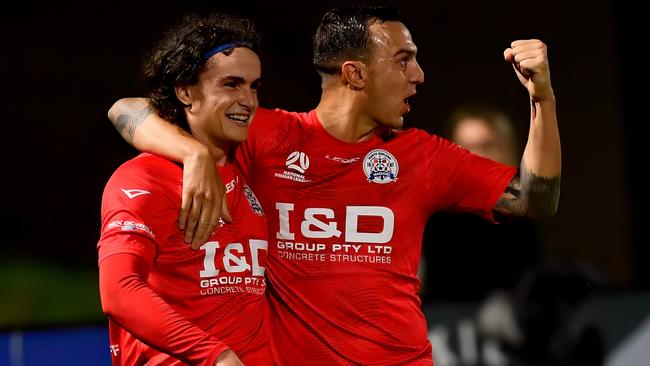 George Elliss is congratulated after scoring a goal.