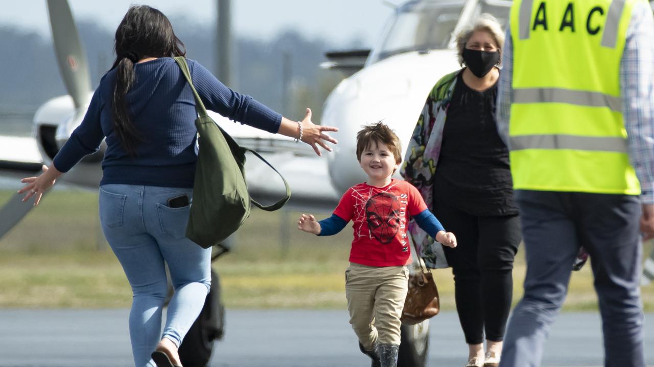 Memphis reunites with his mum Dominique Facer at Archerfield airport. Picture Lachie Millard