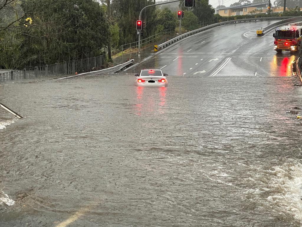 Two people including a child were rescued from a car on Bexley Road, in Sydney’s south, after being stuck in flood water. Picture: SES