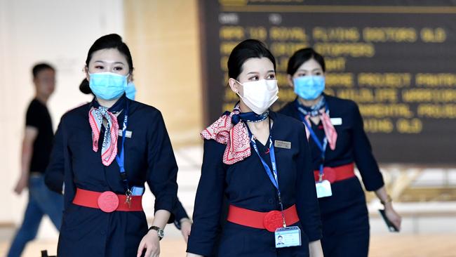 China Eastern Airlines cabin crew are seen wearing protective face masks at Brisbane International Airport