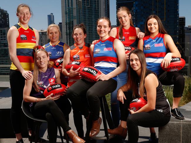 MELBOURNE, AUSTRALIA - OCTOBER 18: (L-R) Jessica Allan of the Crows, Stephanie Cain of the Dockers, Jordan Zanchetta of the Lions, Jodie Hicks of the Giants, Isabel Huntington of the Bulldogs, Eden Zanker of the Demons, Chloe Molloy of the Magpies and Monique Conti of the Bulldogs pose for a photograph during the 2017 NAB AFL Women's Draft at Docklands on October 18, 2017 in Melbourne, Australia. (Photo by Michael Willson/AFL Media/Getty Images)