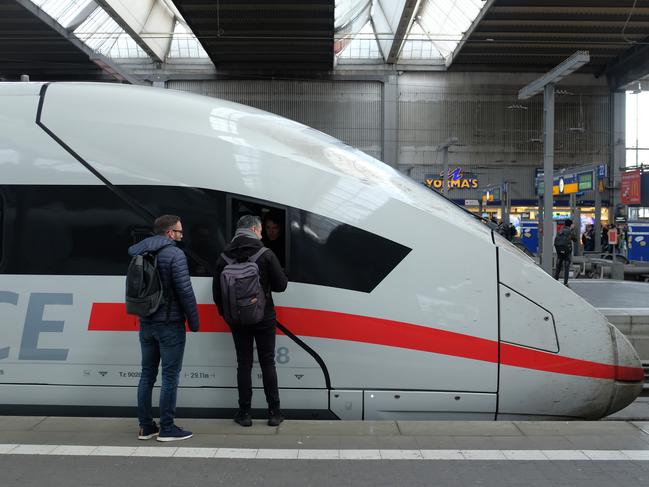 Men chat with the engineer of a high-speed Deutsche Bahn ICE train bound for Berlin in Munich, Germany. German state rail carrier Deutsche Bahn has announced it will invest EUR 12 billion in coming years in new trains. Picture: Sean Gallup