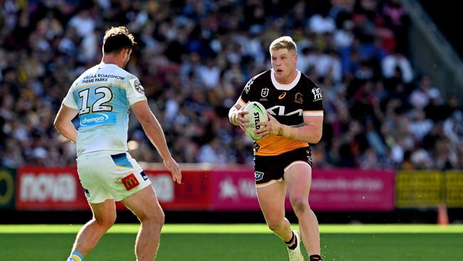 BRISBANE, AUSTRALIA - JUNE 25: Tom Flegler of the Broncos looks to take on the defence of Joe Stimson of the Titans during the round 17 NRL match between Brisbane Broncos and Gold Coast Titans at Suncorp Stadium on June 25, 2023 in Brisbane, Australia. (Photo by Bradley Kanaris/Getty Images)