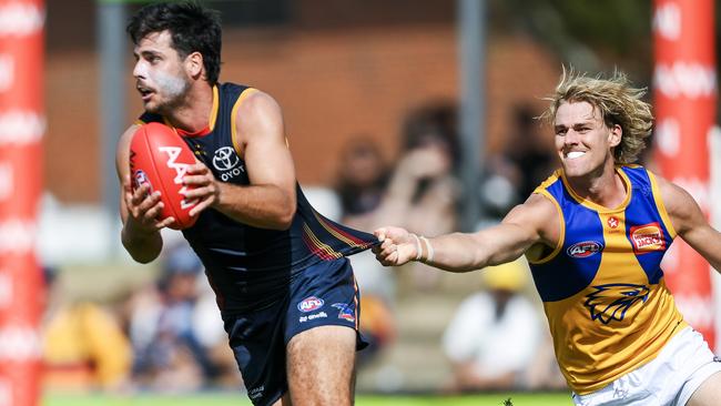 Crows forward Darcy Fogarty tries to break clear of Eagle Callum Jamieson in the practice match at Richmond Oval. Picture: Mark Brake/Getty Images