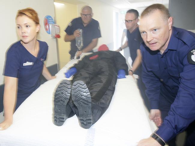 Midwife Tarryn O'Loughlin, Fire safety officer Rod Brown, registered Nurse Simon Latham and Fire safety officer David McSwan simulate removing a patient from a smoke filled environment in RPA's new Fire simulation unit. Picture: John Appleyard