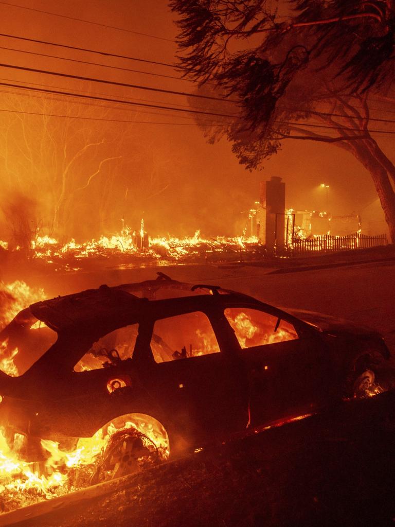 The Palisades Fire burns vehicles and structures in the Pacific Palisades neighbourhood of Los Angeles. Picture: Photo/Ethan Swope.