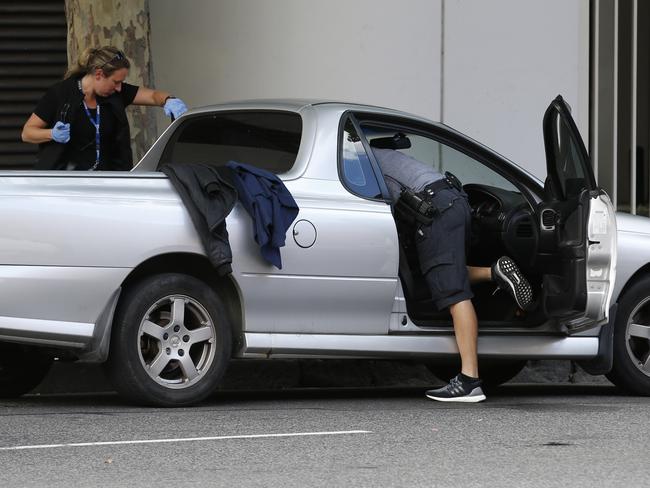 Police search a ute outside the Melbourne Assessment Prison. Picture: David Caird