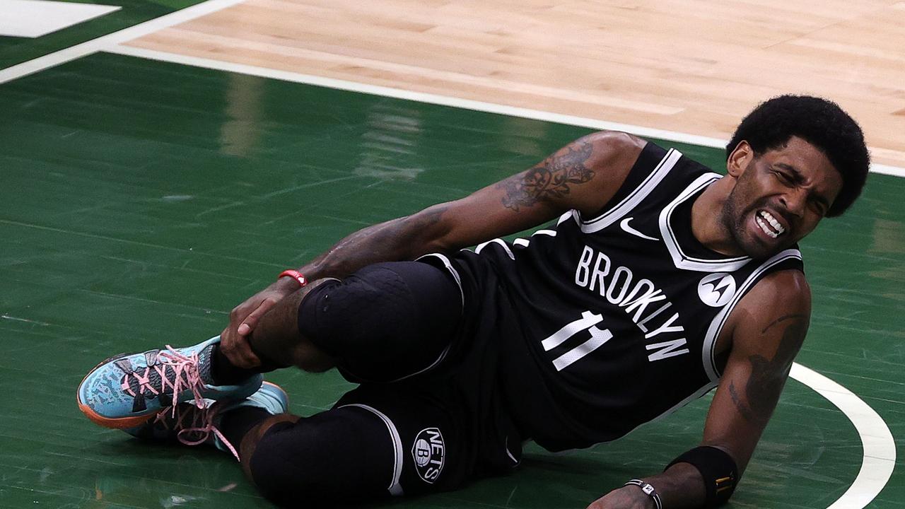 MILWAUKEE, WISCONSIN - JUNE 13: Kyrie Irving #11 of the Brooklyn Nets is injured during the first half of Game Four of the Eastern Conference second round playoff series against the Milwaukee Bucks at the Fiserv Forum on June 13, 2021 in Milwaukee, Wisconsin. NOTE TO USER: User expressly acknowledges and agrees that, by downloading and or using this photograph, User is consenting to the terms and conditions of the Getty Images License Agreement. (Photo by Stacy Revere/Getty Images)