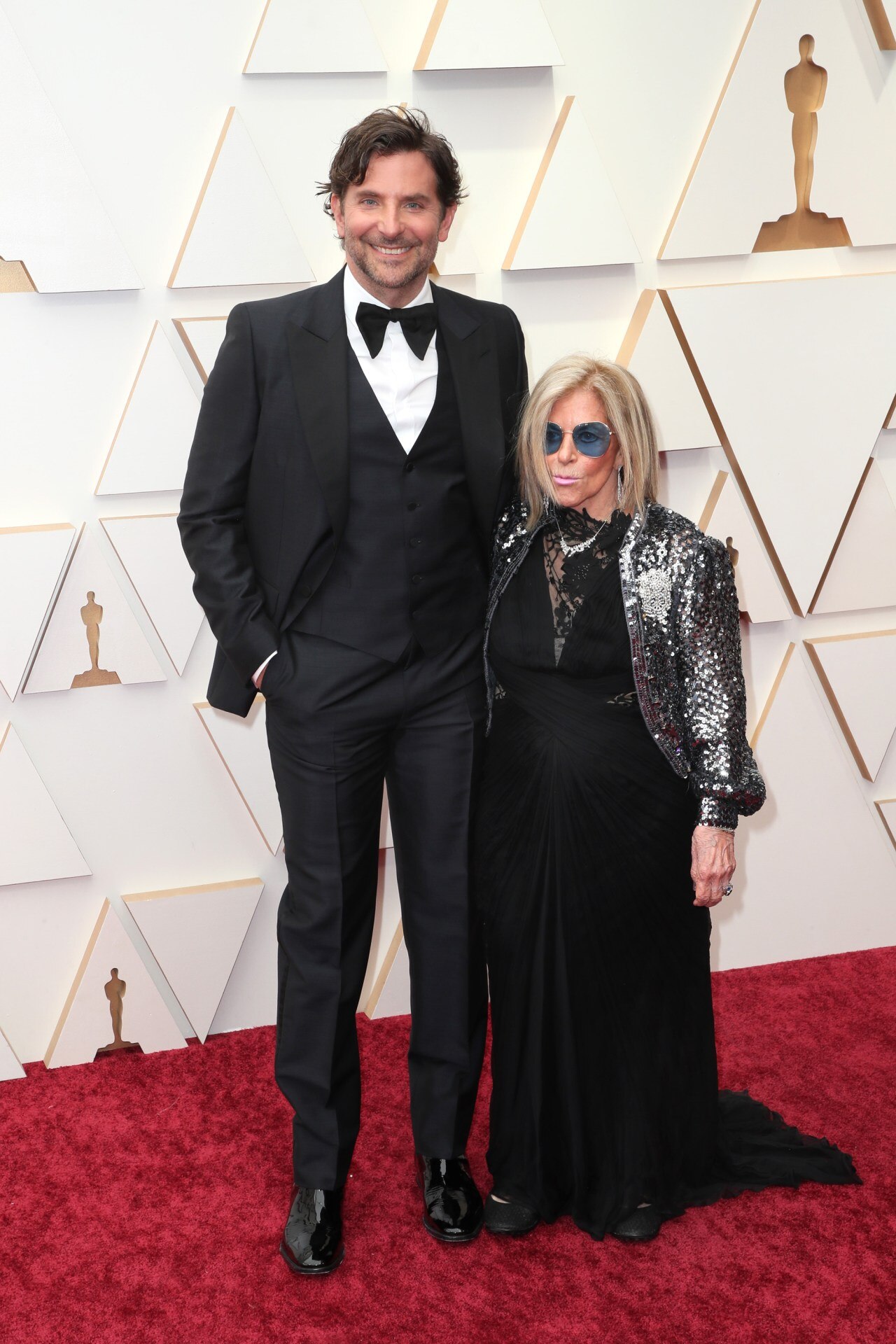 <p>With Gloria Campano in one of his many three piece suits at the 94th Annual Academy Awards.</p>