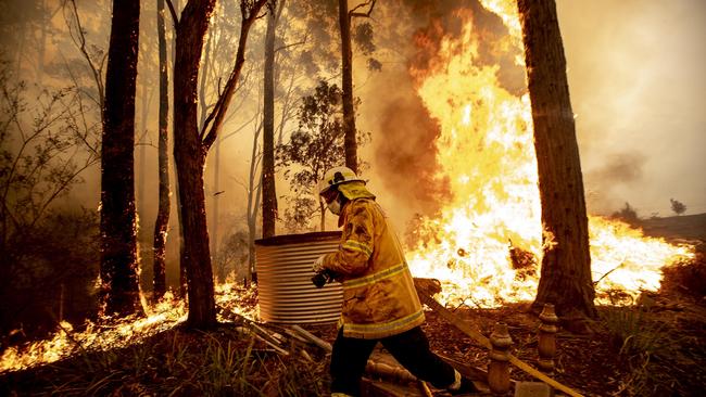 A firefighter works to save a home at Termiel on December 4. Picture: Gary Ramage