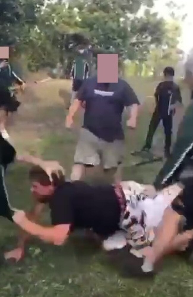 A father brawls with students outside a Logan school.