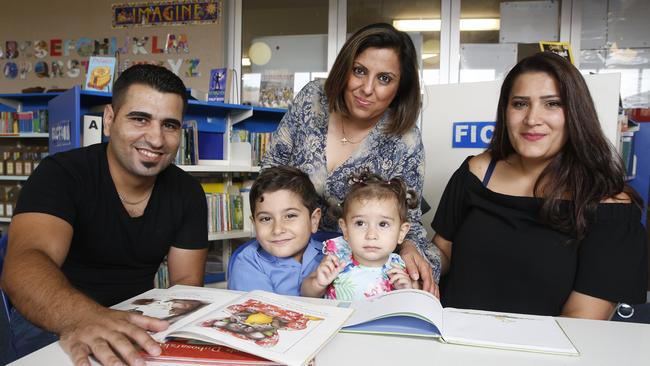 Iraqi Translator Sana Yonan (middle) teaching English at Mt Druitt. Picture: David Swift