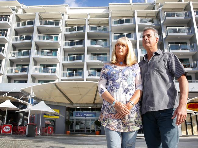 Apartment owners Jenny and Simon Anderson out the front of the Oaks resort this week where repair work, costing $6.8 million, has already been done to salvage the landmark building at The Entrance. Picture: Mark Scott