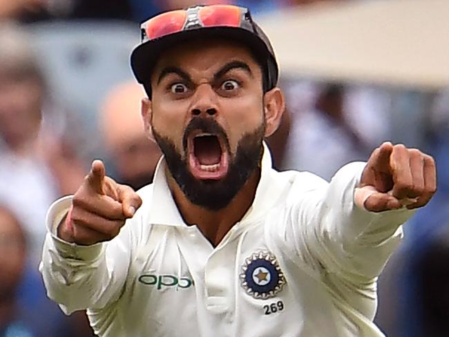 India's captain Virat Kohli celebrates the wicket of Australia's Pat Cummins on the final day of the third cricket Test match between Australia and India in Melbourne on December 30, 2018. (Photo by WILLIAM WEST / AFP) / -- IMAGE RESTRICTED TO EDITORIAL USE - STRICTLY NO COMMERCIAL USE --