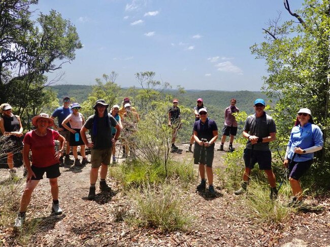 Sonia Wray (pink shirt) and HIKEFit group at Lost World Lookout in the Blue Mountains National Park. Image Supplied.