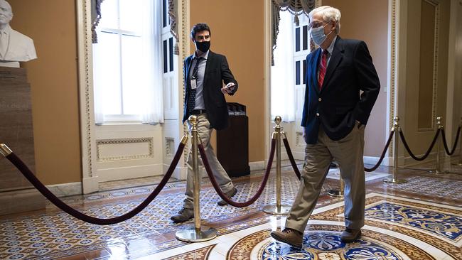 US Senate Majority Leader Mitch McConnell walks back to his office on Capitol Hill after Republicans and Democrats in the Senate finally came to an agreement on the coronavirus relief bill.