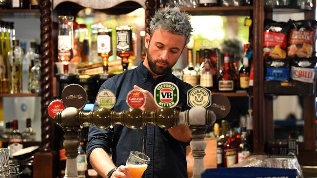 A barman pours a beer at the Glenferrie Pub in Melbourne. Picture: AAP