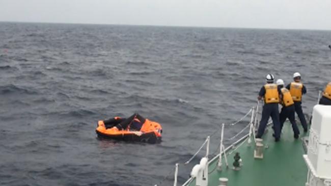 Japan Coast Guard rescue a man from a life raft about 2km north-northwest of Kodakarajima island of Kagoshima prefecture. Picture: AFP PHOTO/JAPAN COAST GUARD