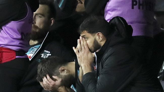 Charlie Dixon, Sam Gray and Paddy Ryder are shattered on the bench as Jeremy McGovern kicks to win the match. Picture Sarah Reed