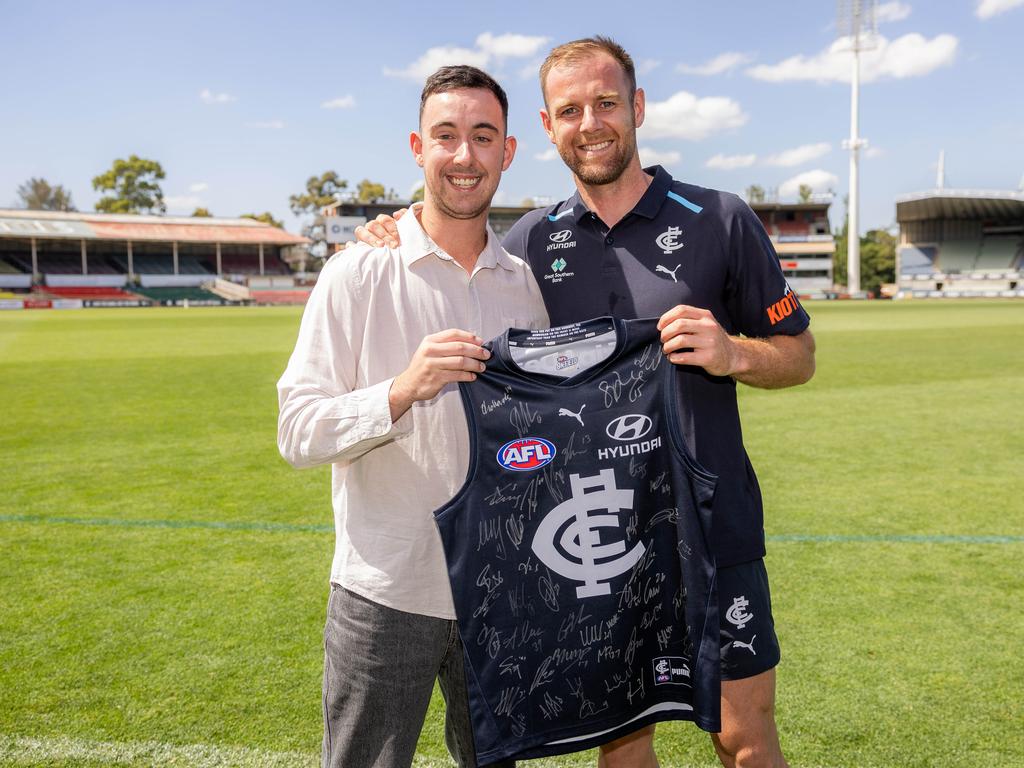 Sam Docherty gives Liam Contarin a signed jumper. Carlton footballer Sam Docherty is donating $30,000 to Peter Mac for cancer research and $10,000 to McKillop Family Services. It is from his Jim Stynes award – Sam had cancer and will be pictured with a 23-year-old Blues fan Liam Contarin who was diagnosed with the same cancer around the same time. Picture: Jason Edwards