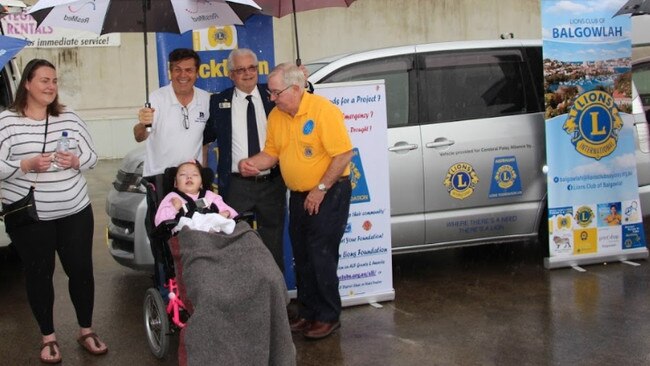 Kate Agnihotri (far left) and daughter Kareena (below) are gifted an accessible car after fundraising efforts by a group of Lions Clubs. Picture: supplied