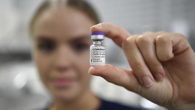 Registered nurse Christina O'Donnell holds a vial of the Pfizer COVID-19 vaccine. Picture: Ian Hitchcock