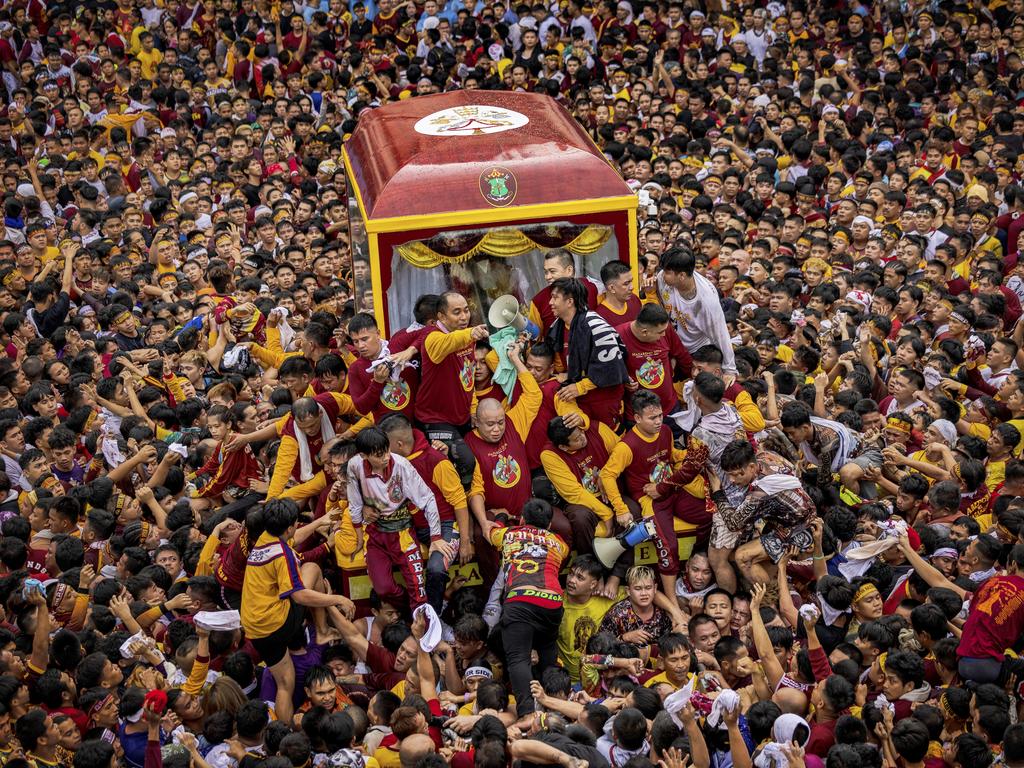 Filipino devotees jostle as they attempt to touch the carriage carrying the statue of the Black Nazarene, a sculpture of Jesus brought to the Philippines from Spain in 1606 and considered miraculous by Filipino faithful. Picture: Ezra Acayan/Getty Images