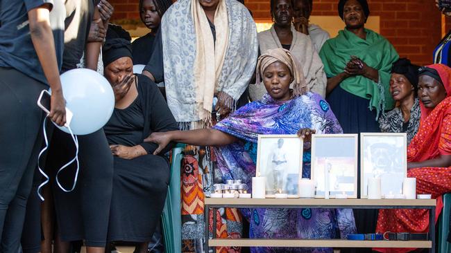 The families of the slain young men unite in grief. Picture: Mark Stewart