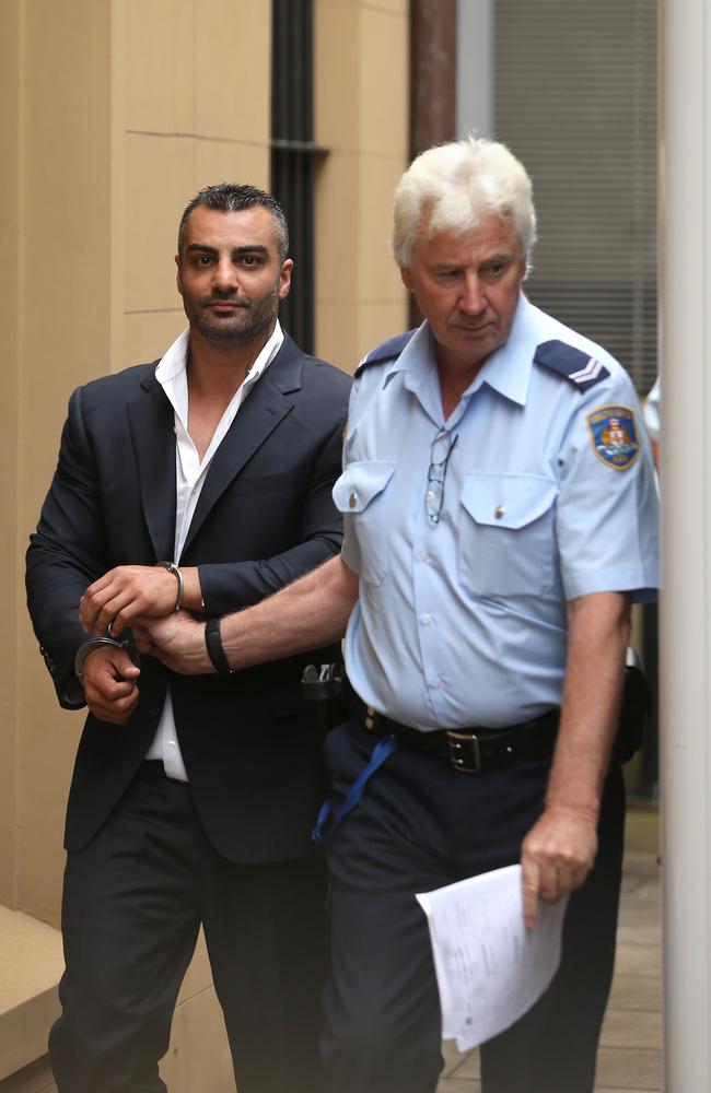 Mick Hawi smirks as he leaves Kings Street Courts in custody. Picture: Bradley Hunter